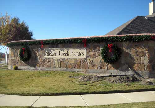 Subdivision Entrance Decorated with Christmas Lights
